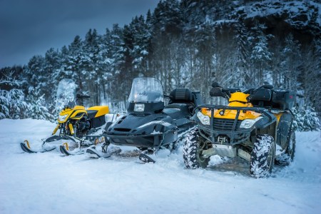 Winter Motorcycle. Snowmobile. Winter ATVs. Winter ATVs in winter against the backdrop of the mountain.