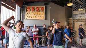 A group of men throw axes at forged