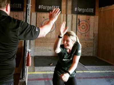 29092704_416693842119022_2023283097994264576_n friends high fiving at forged axe