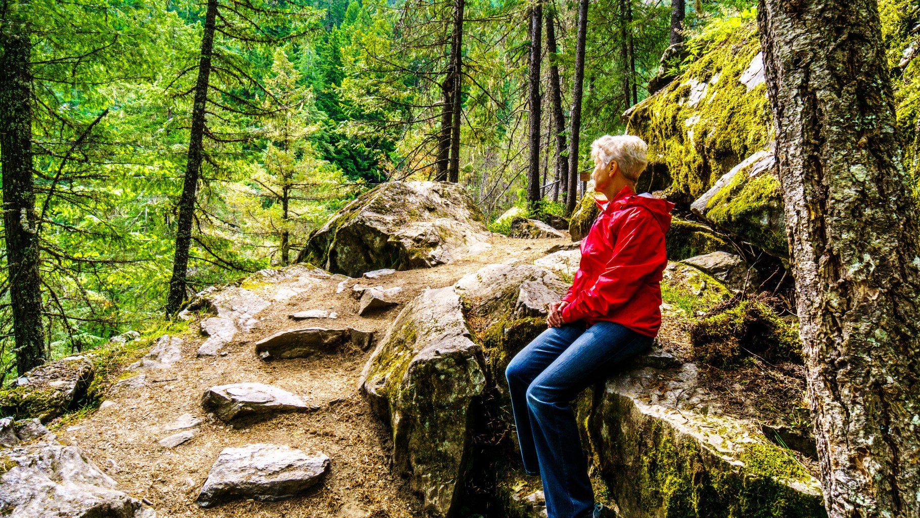 Woman resting on a hike alongside the Lillooet River to Nairn Fa