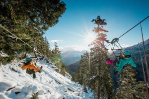 Two people ziplining in Whistler in Winter