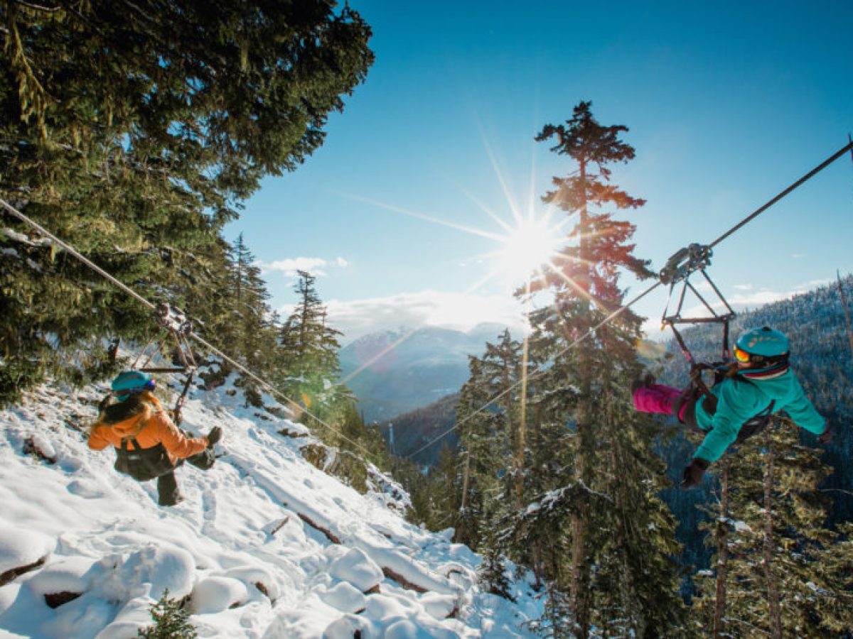 Two people ziplining in Whistler in Winter