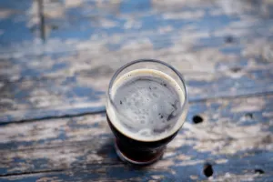 An image of a beer in a glass on a table.