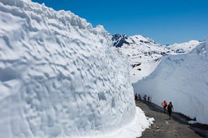 Walls of snow surrounding a trail on whistler mountain