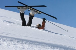 A skier upside-down on the snow