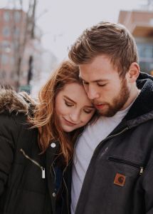 Two people snuggling in whistler in Winter