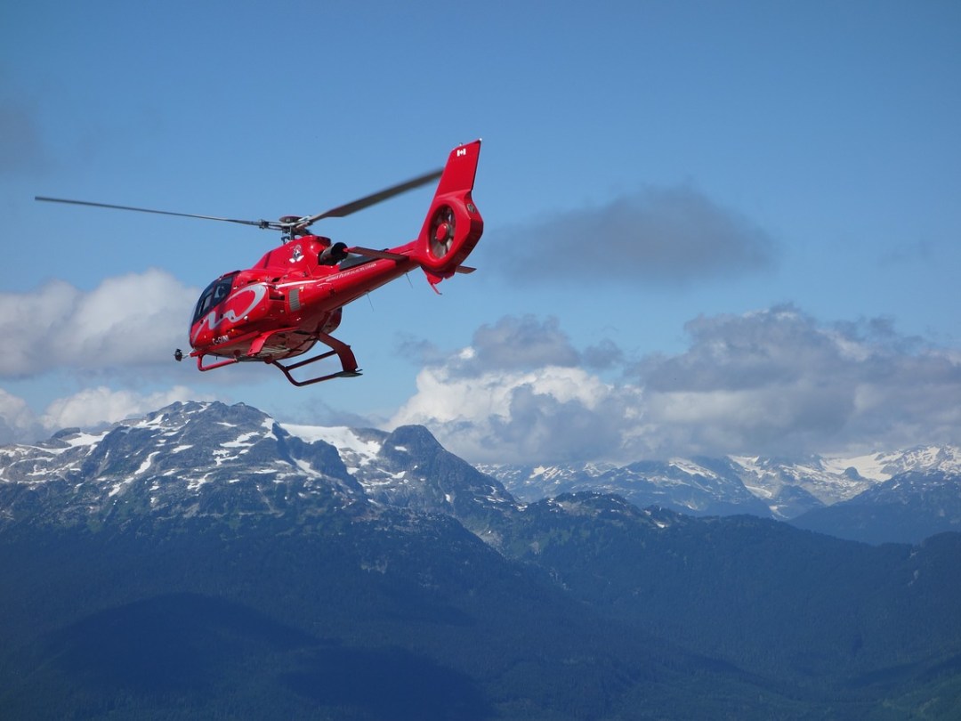 a person flying through the air on a snow covered mountain