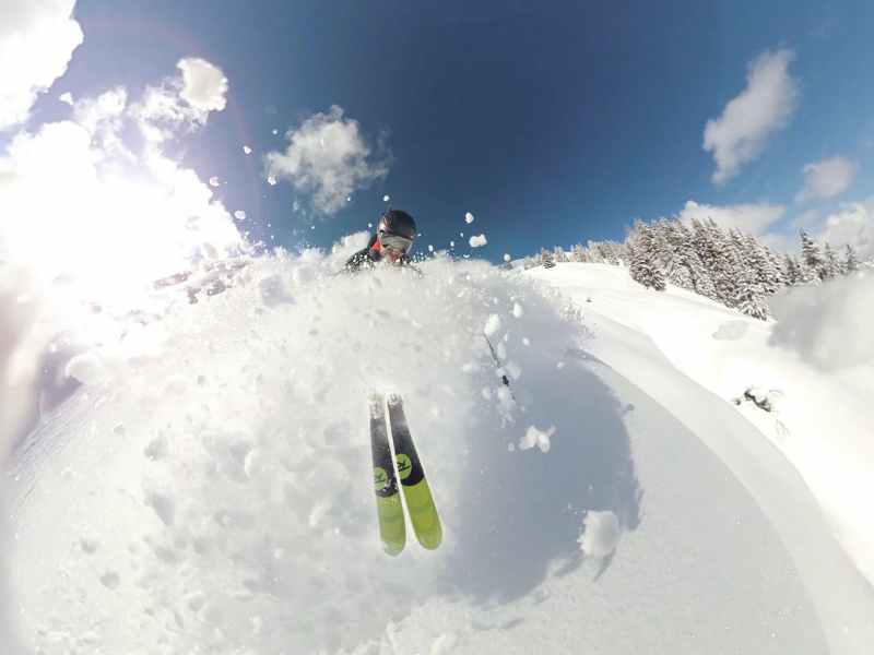 pexels-photo-869263 a man riding a snowboard down a snow covered slope