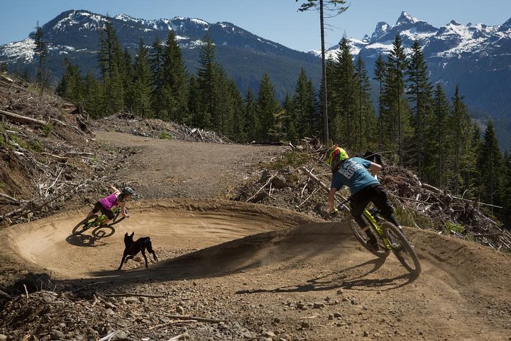 a man riding a bike down a dirt road